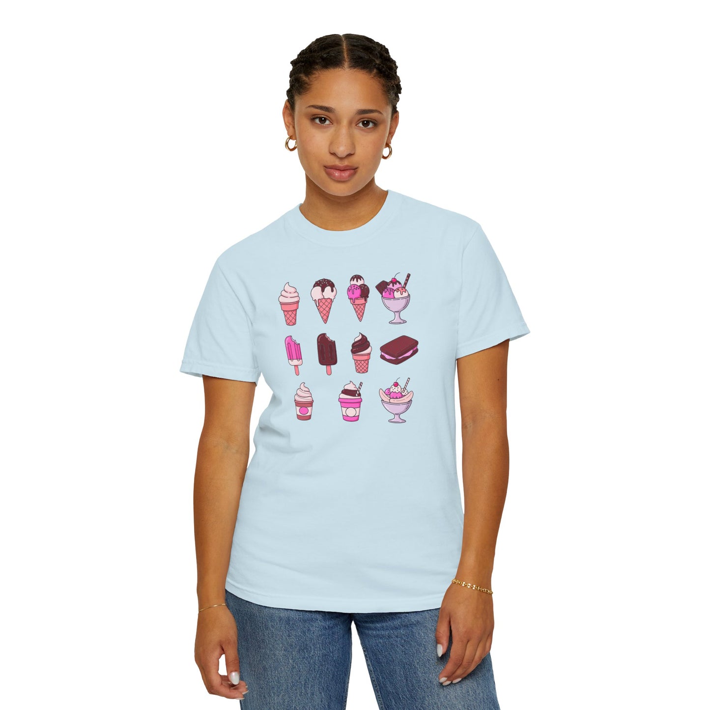 Person wearing a light blue t-shirt with ice cream graphics on a white background