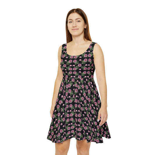 Woman wears the Moni Lee Pink flower summer dress black