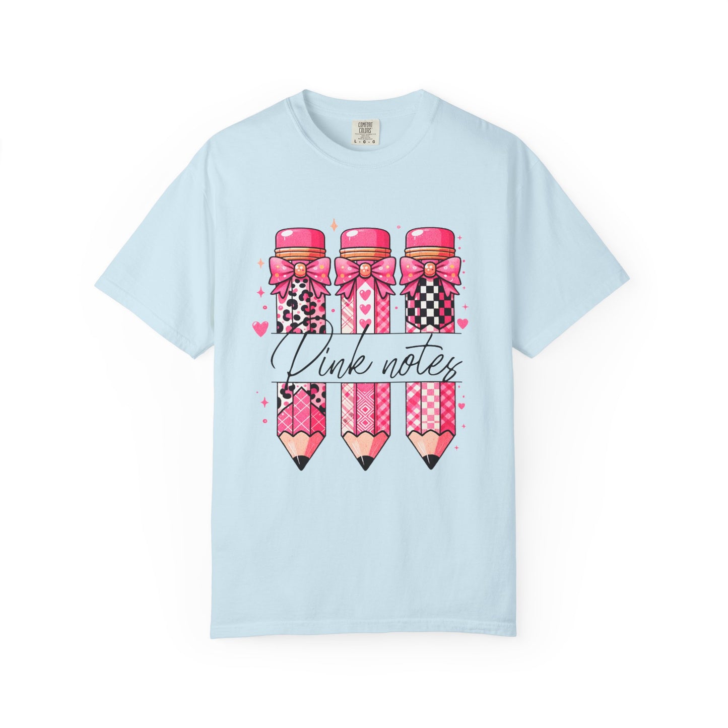 Light blue t-shirt with pink pencils and bows design on a white background