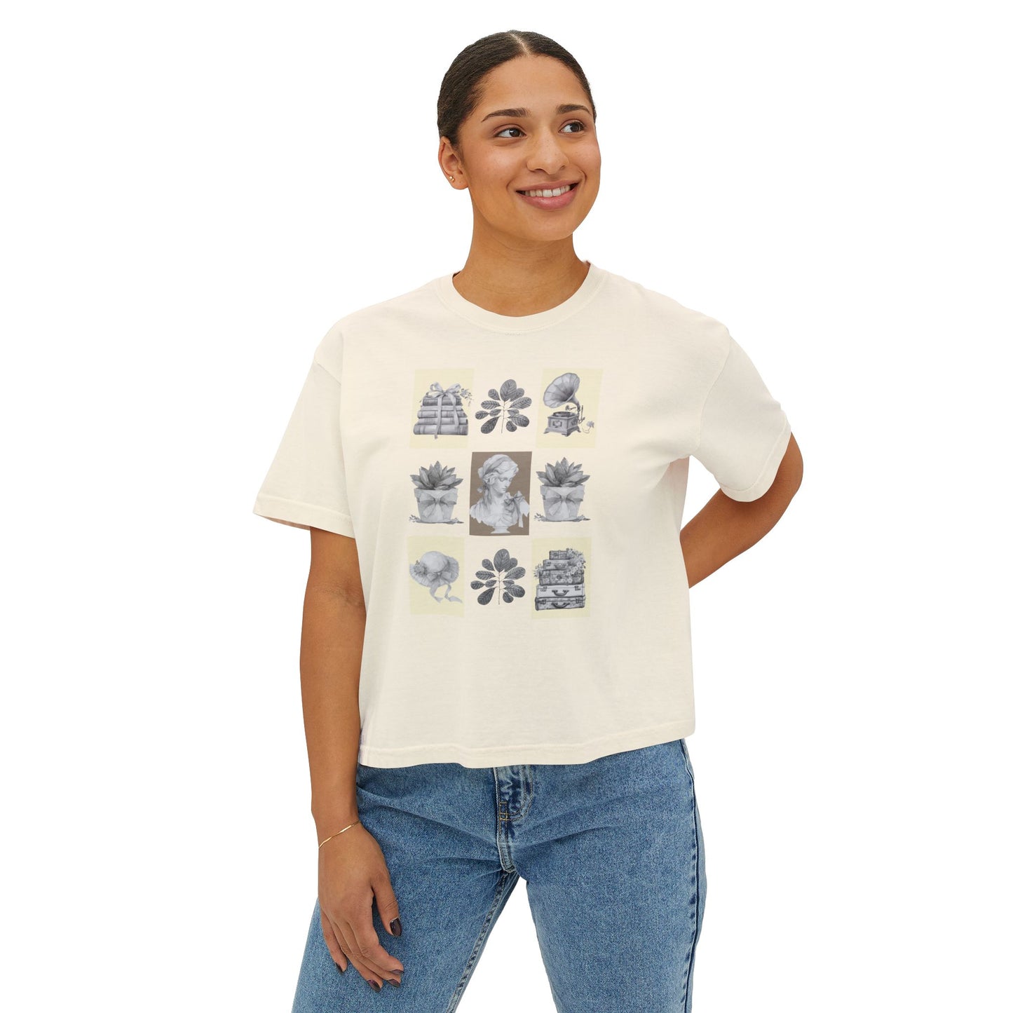 Woman wearing a ivory t-shirt with graphic designs on a white background