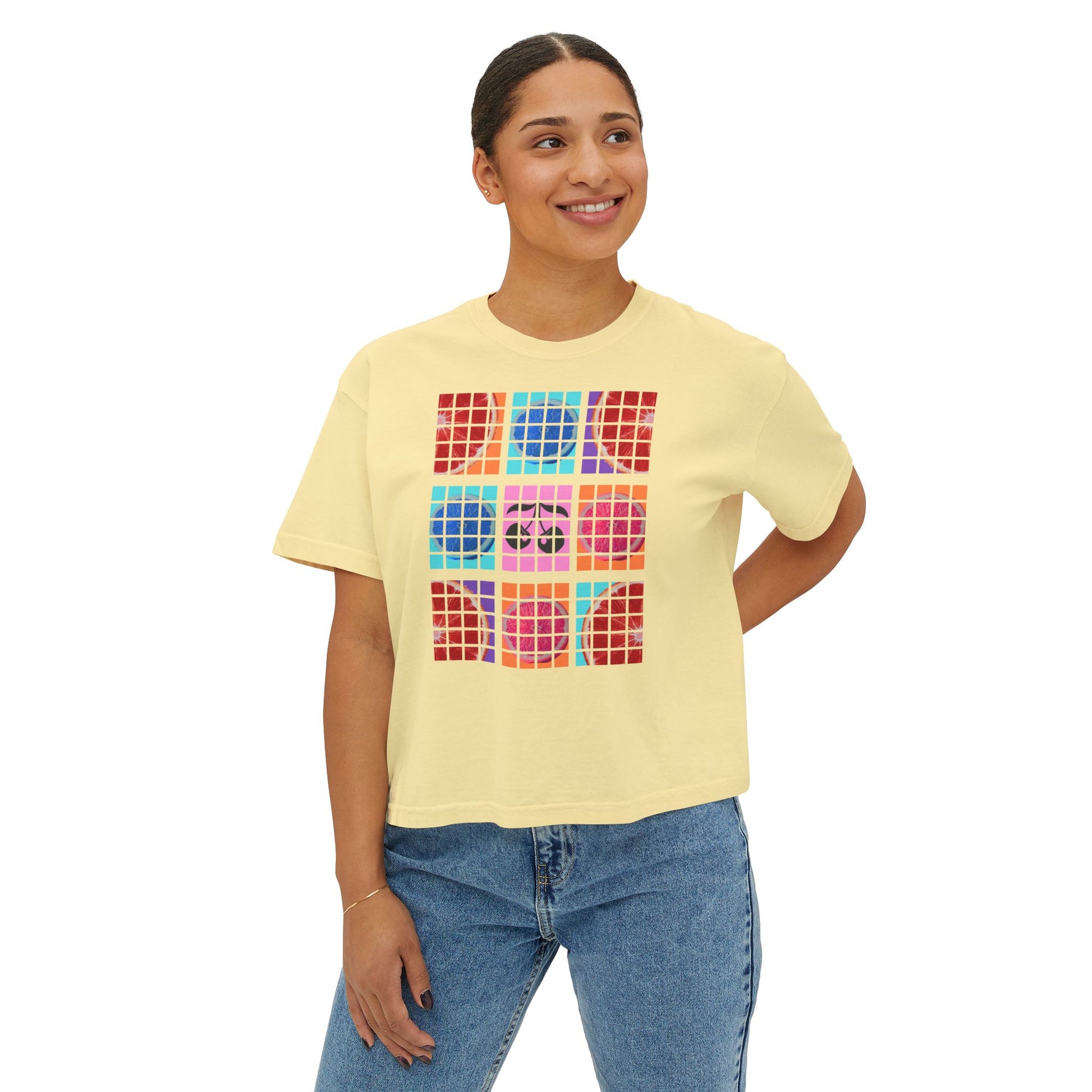Woman wearing a yellow t-shirt with colorful geometric design on a white background