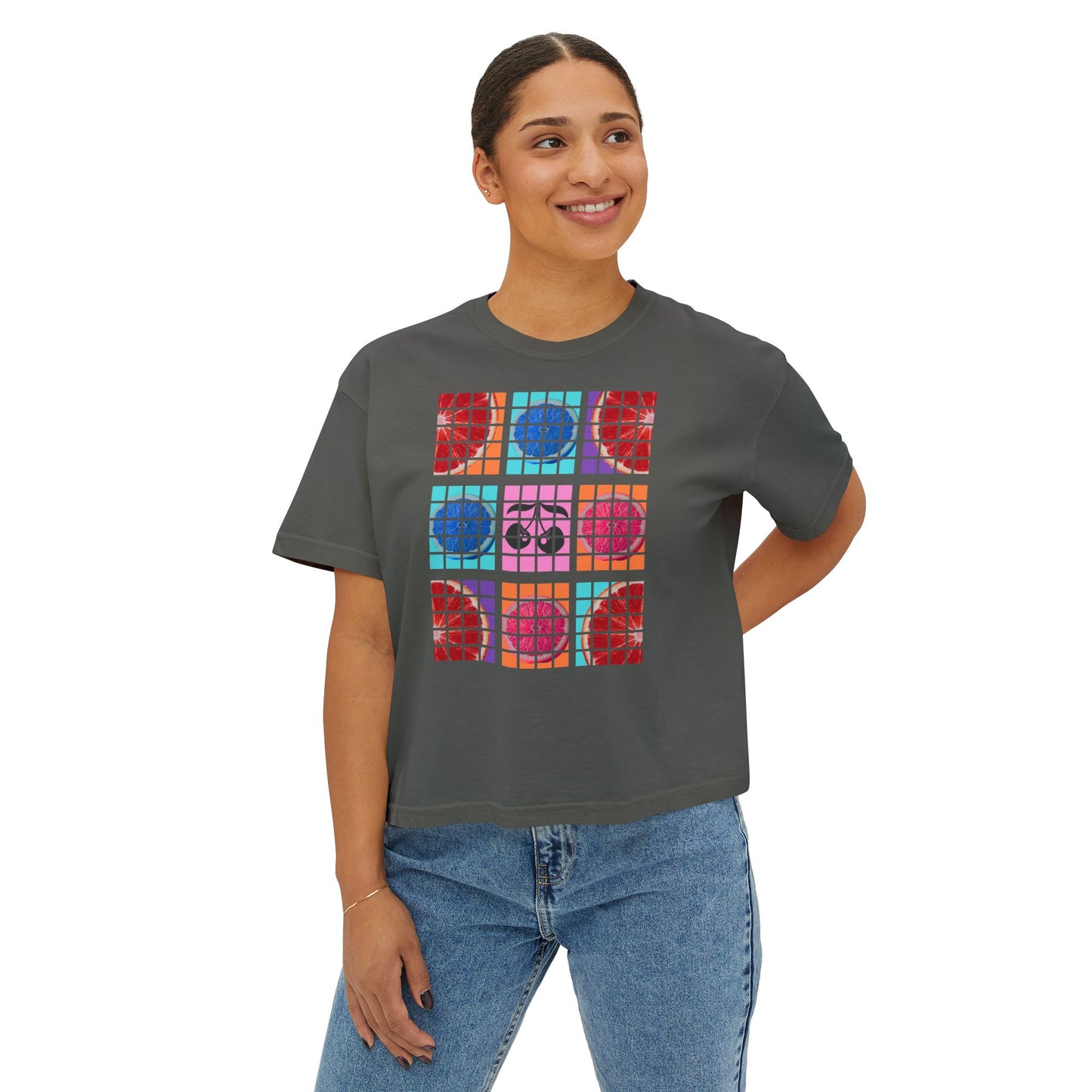 Person wearing a gray t-shirt with colorful geometric pattern on a white background