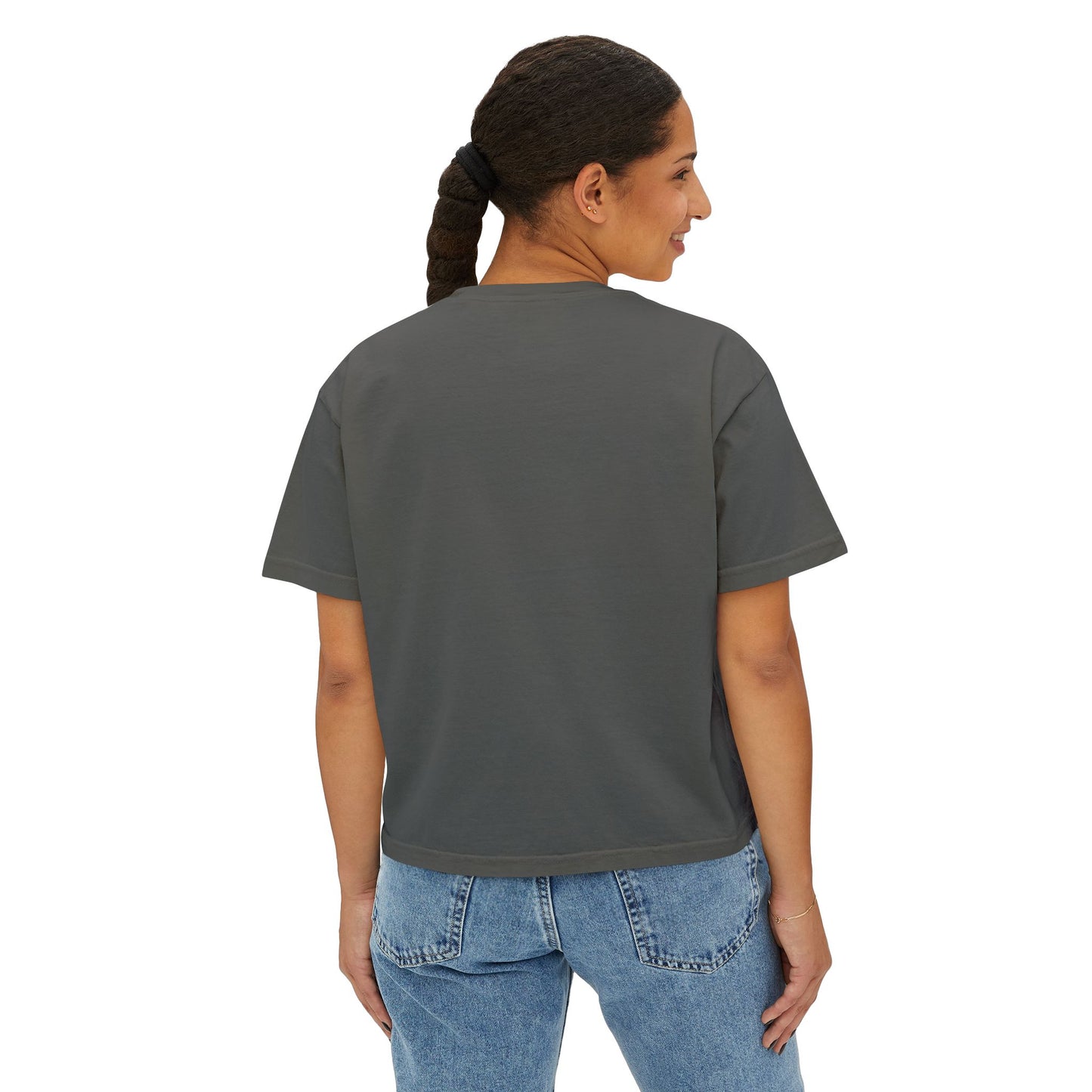 Person wearing a dark gray t-shirt and blue jeans on a white background
