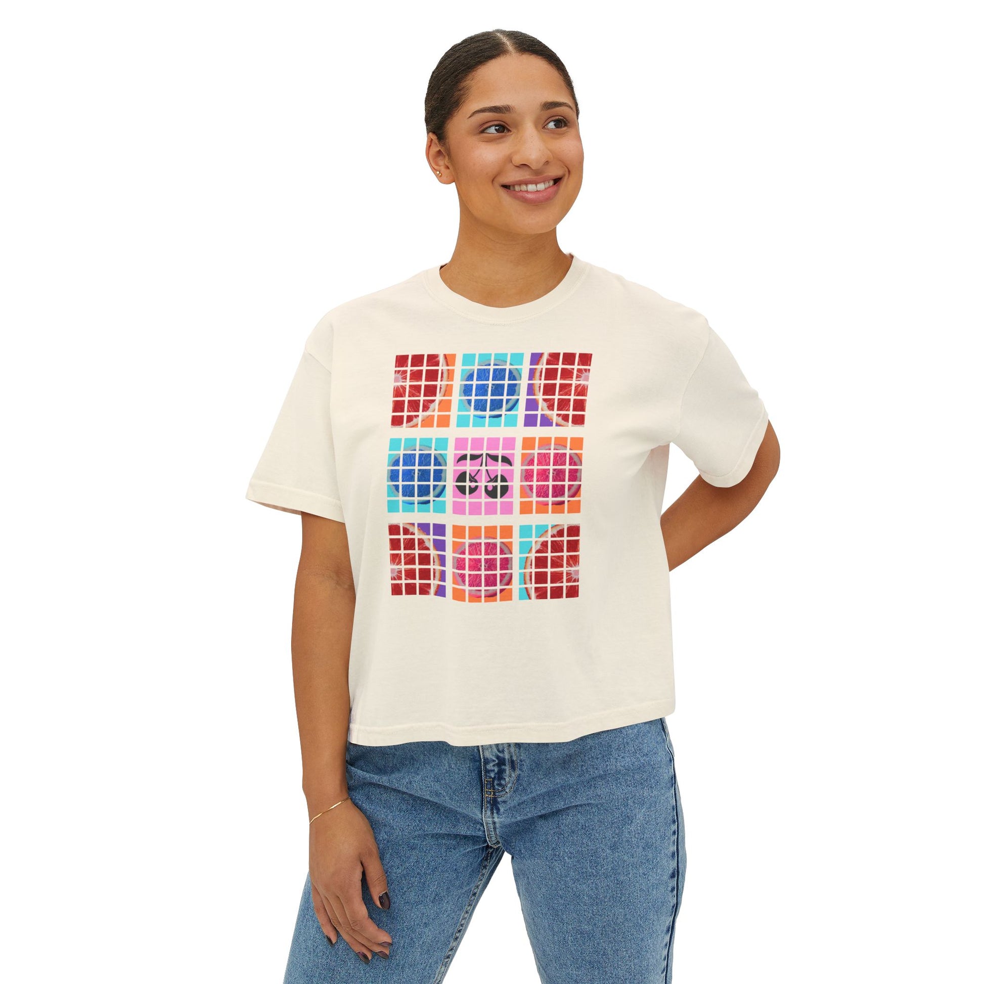 Woman wearing a white t-shirt with colorful geometric design on a white background