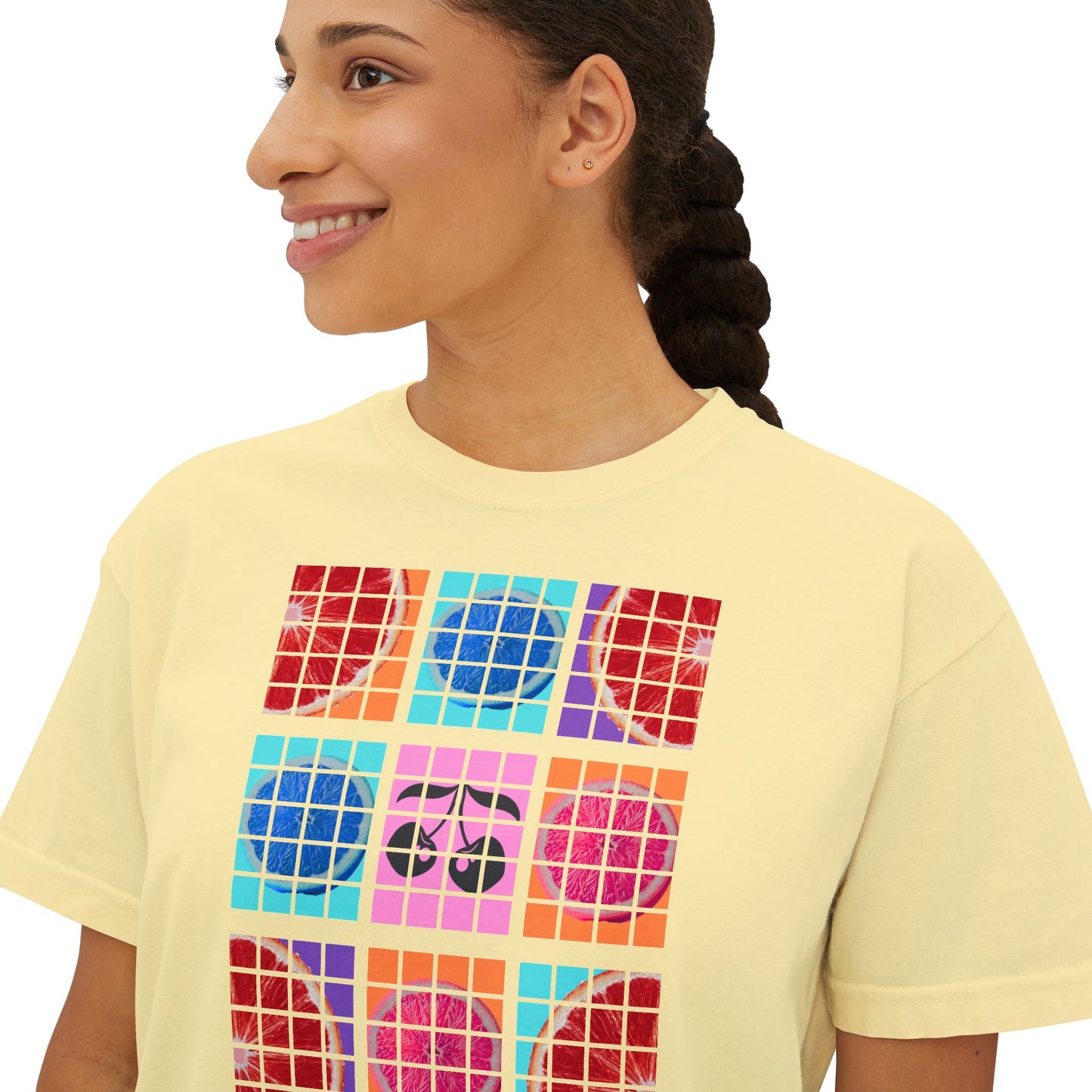 Person wearing a yellow t-shirt with colorful geometric design
