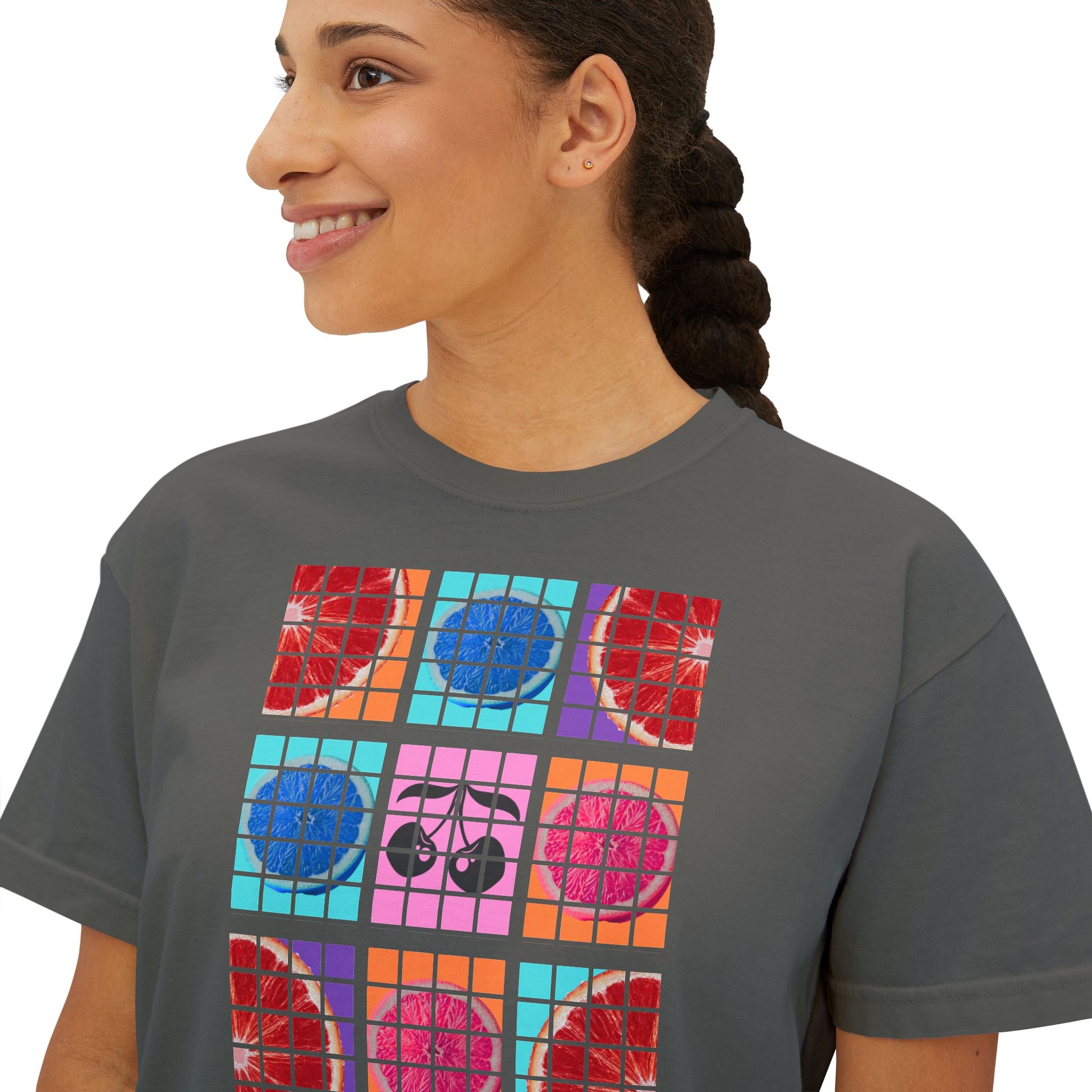 Person wearing a gray t-shirt with colorful graphic design on a white background
