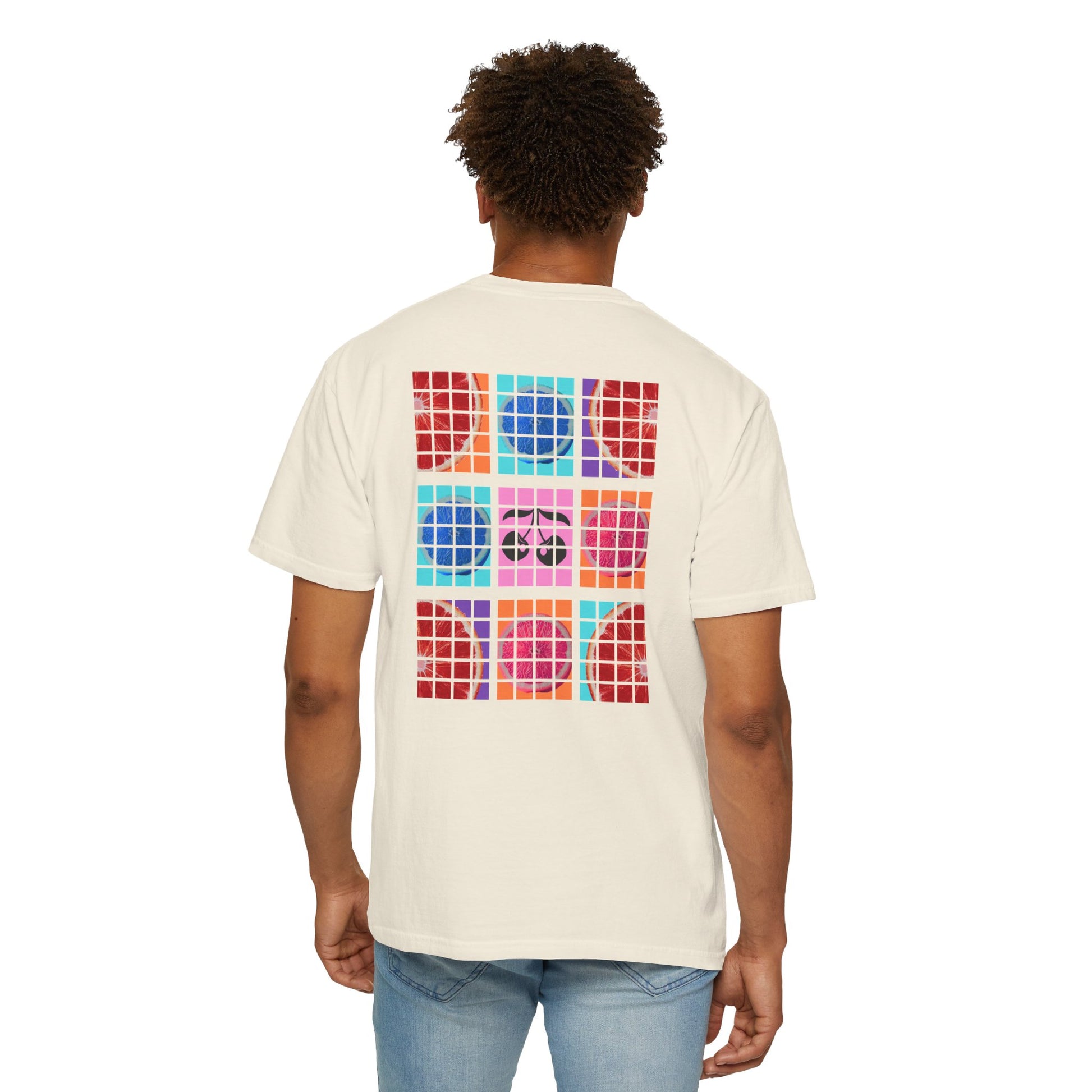 Person wearing a white t-shirt with colorful geometric pattern on the back