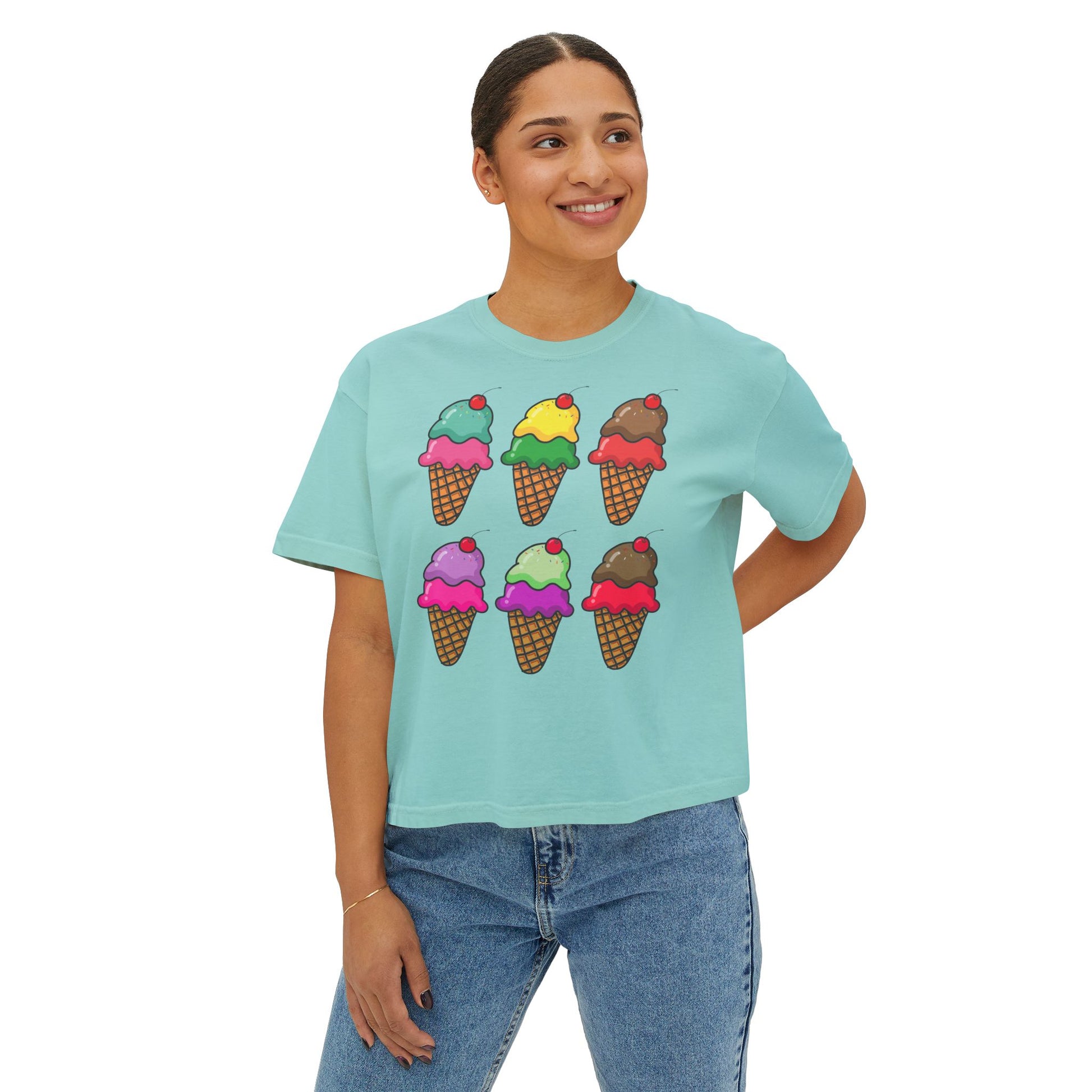 Person wearing a light blue t-shirt with ice cream cone designs on a white background