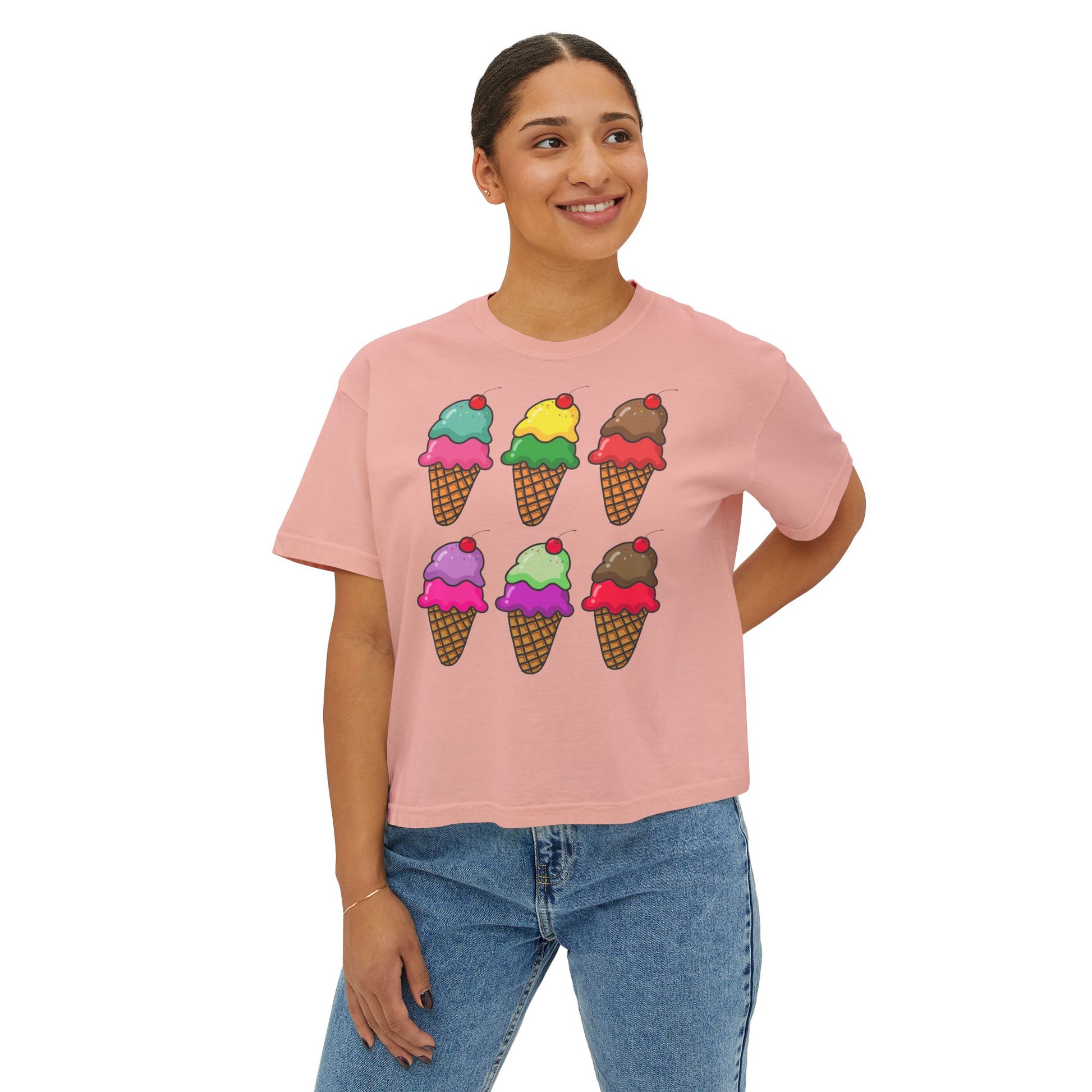 Person wearing a pink t-shirt with ice cream cone graphics on a white background