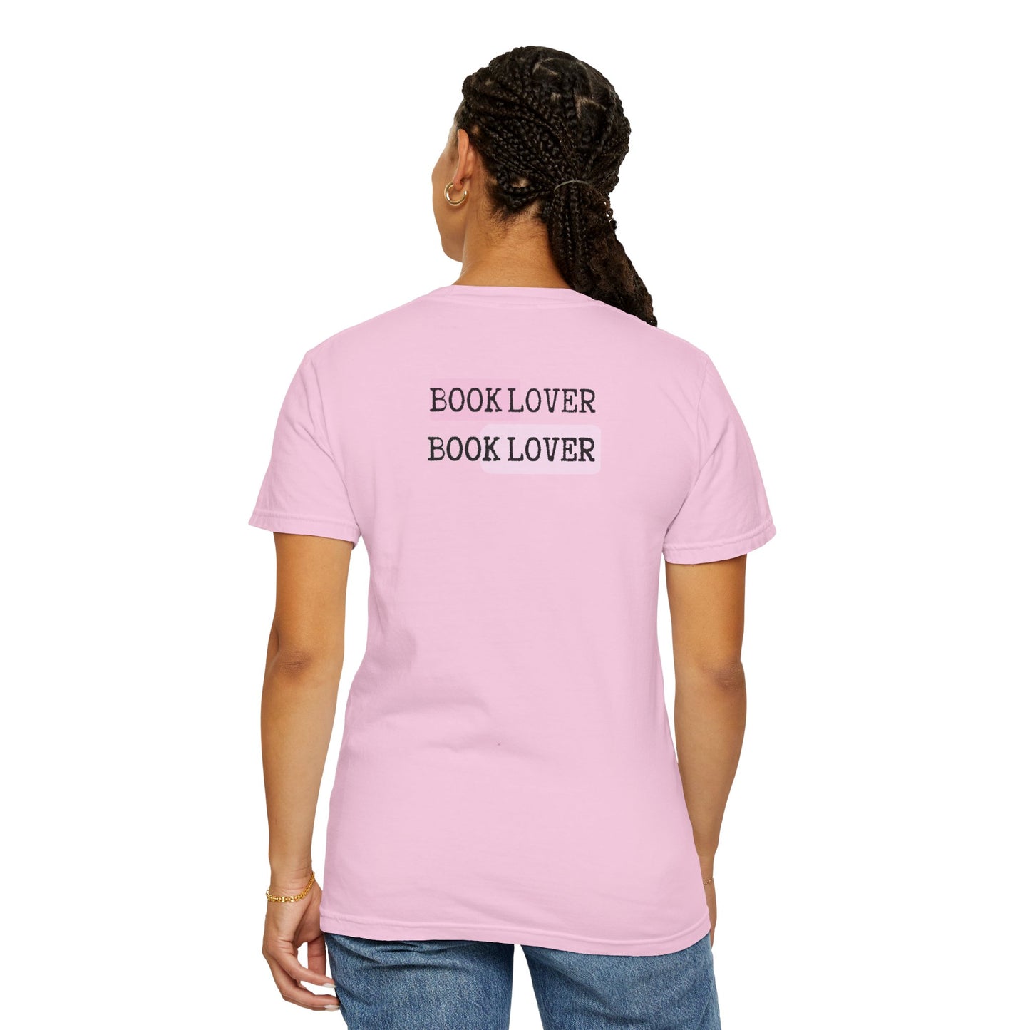 Person wearing a pink t-shirt with 'BOOK LOVER BOOK LOVER' text on the back.
