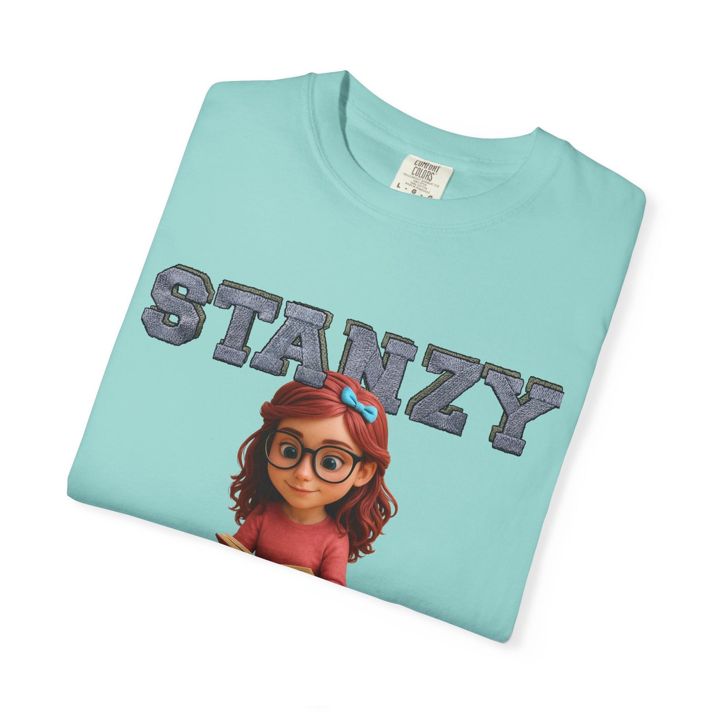 Folded light blue t-shirt with 'STANZY' and cartoon character on a white background