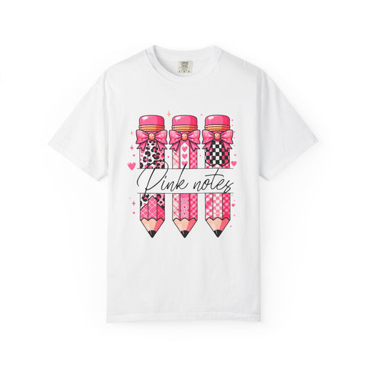 White t-shirt with pink pencils and bows design on a white background