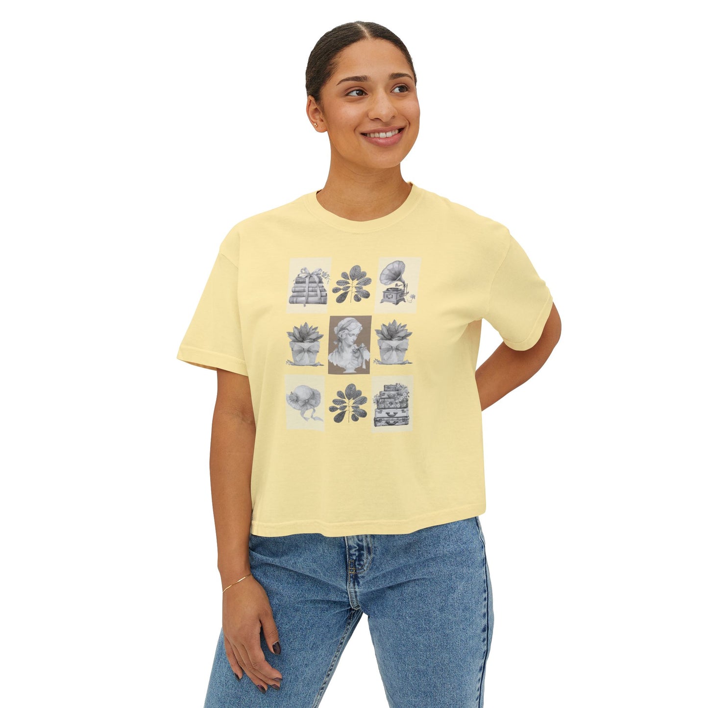 Woman wearing a butter t-shirt with graphic designs on a white background